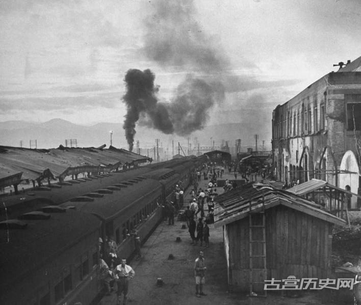 黎明时分在被炸弹炸毁的火车站平台上的士兵和平民，地点：日本广岛。